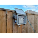 Open temporary power box on a wood fence