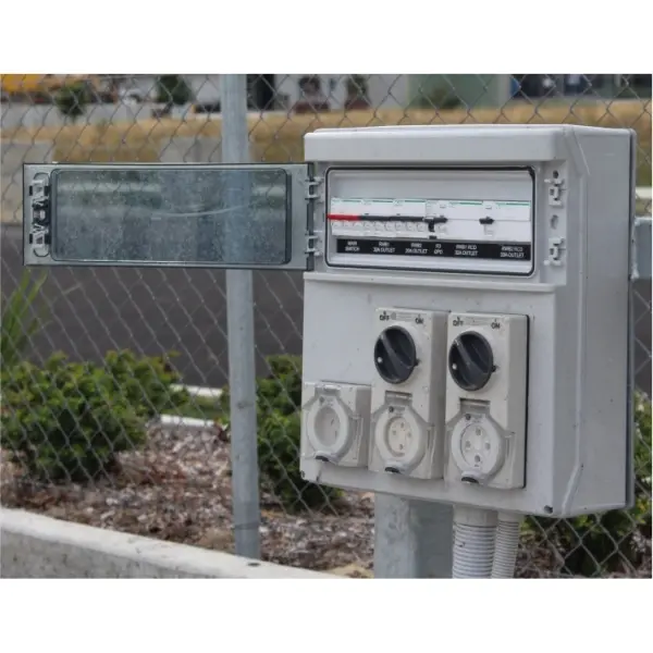 A grey stand-by truck plug board outdoor rated on site with 3 outlets and a hinging window for controls.