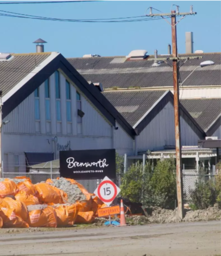 bremworth spinner after flood with blue sky background and orange sandbags